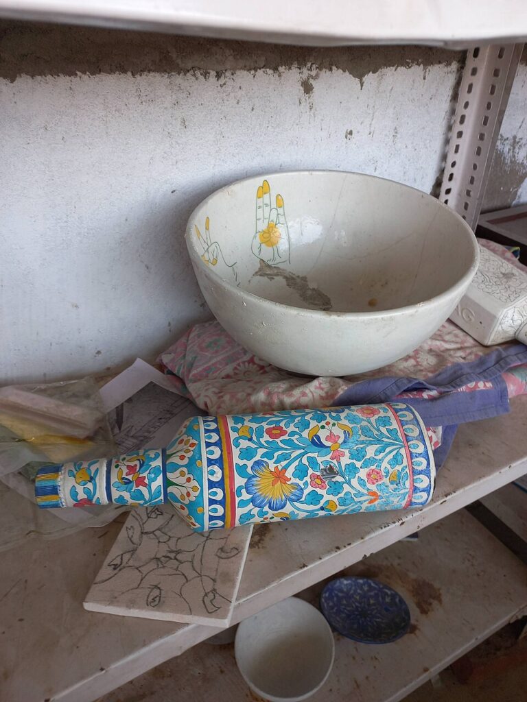 Hand-painted Jaipur blue pottery pieces before glazing and firing