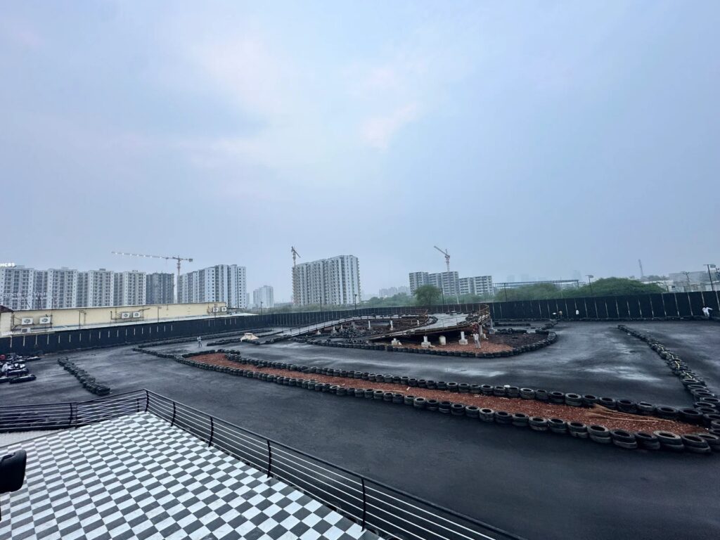 Speedomania outdoor kart track with red signage and tyre barriers near Dwarka Expressway.