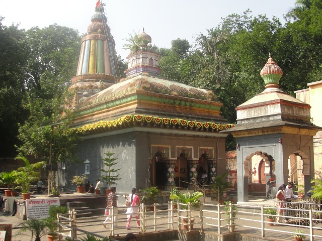 Historic Baneshwar Temple surrounded by trees near Pune.